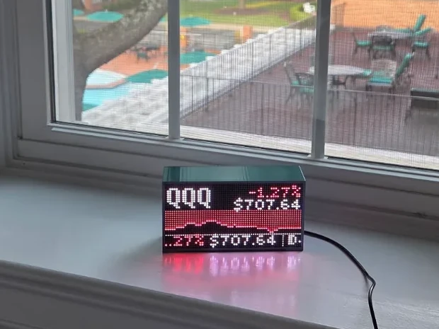 Beekon Light showing a stock ticker scene with a glowing price chart