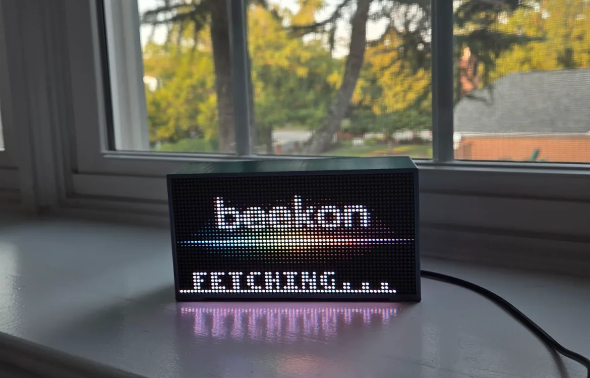 Beekon Light on a windowsill glowing with the word beekon above a rainbow of pixels